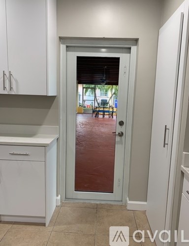 A white door with a glass window in a room.