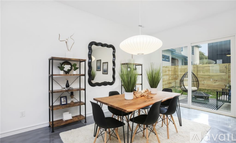 A dining room with a wooden table and chairs.