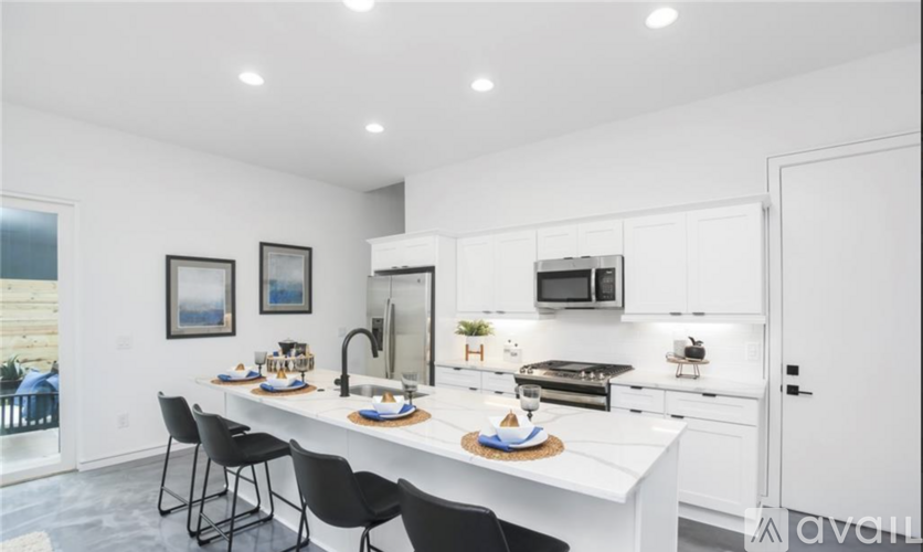 A modern kitchen with a dining table and chairs.