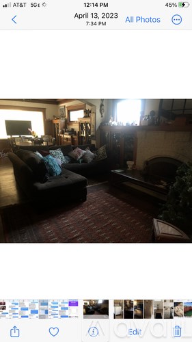A living room with a couch and a fireplace.