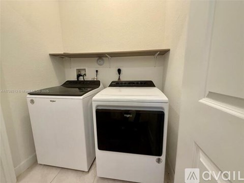 Two white ovens are in a small kitchen.
