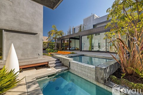 A modern house with a pool in the backyard.