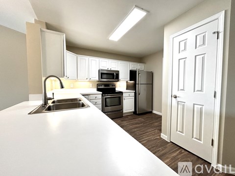 A kitchen with white appliances and a white countertop.