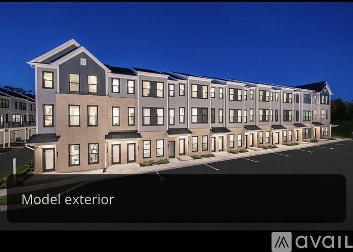A model exterior of a building with a dark sky in the background.