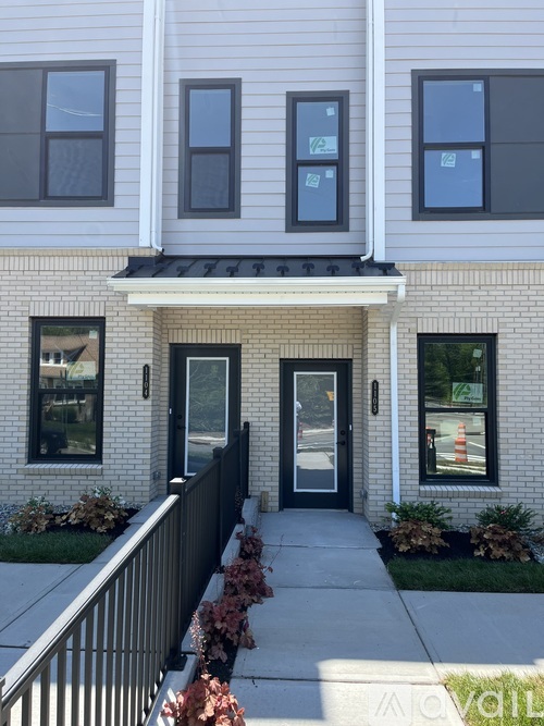A house with a black front door and windows.
