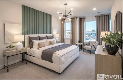A well-lit bedroom with a large bed and a side table.