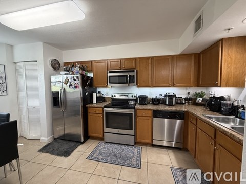 A kitchen with wooden cabinets and stainless steel appliances.