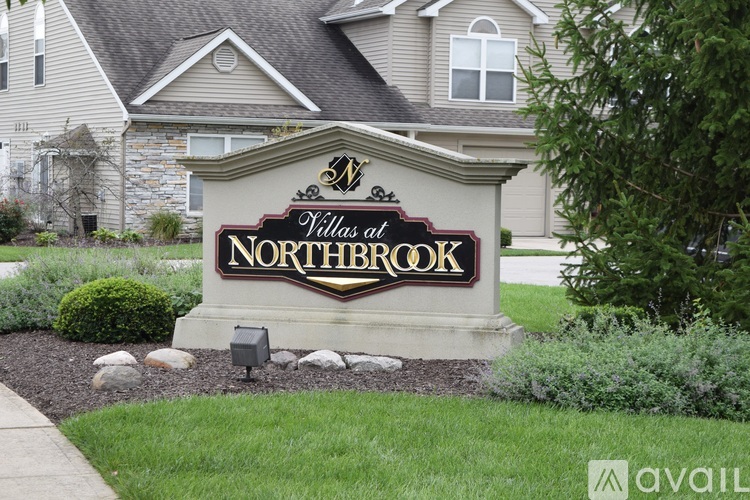 A sign for Northbrook Villas sits in front of a building.
