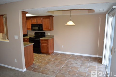 A kitchen with a black microwave and oven.