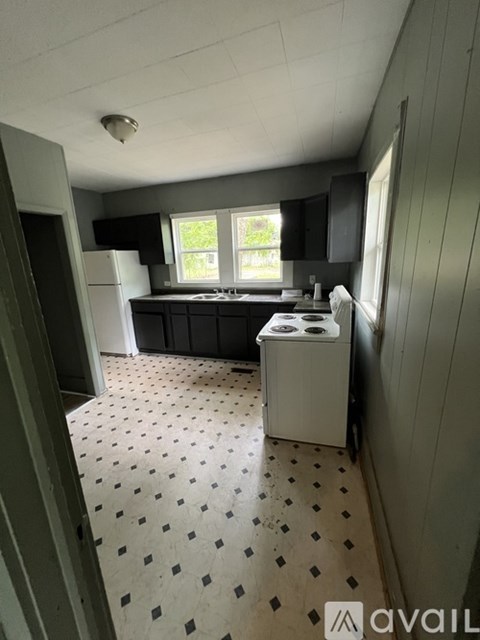 A kitchen with a white fridge and a dishwasher.