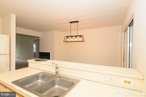 A kitchen with a sink and a light fixture.