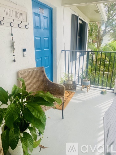 A blue door is on the left side of a white wall.