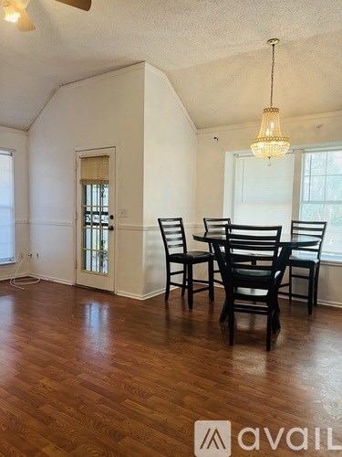 A dining room with a table and chairs.
