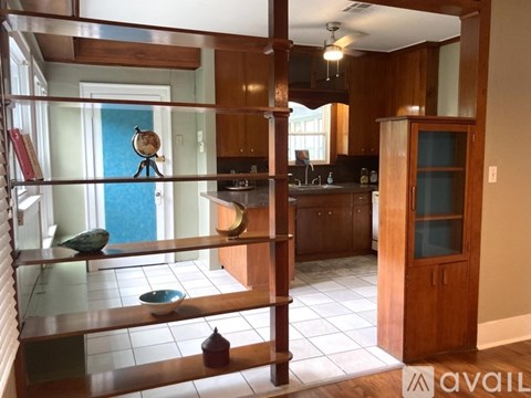 A kitchen with wooden cabinets and a blue door.