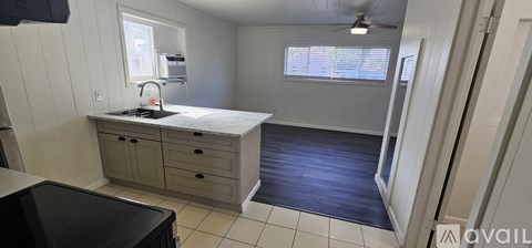 A kitchen with a sink and a window.