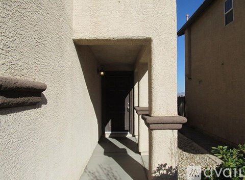 A passageway between two buildings with a doorway at the end.