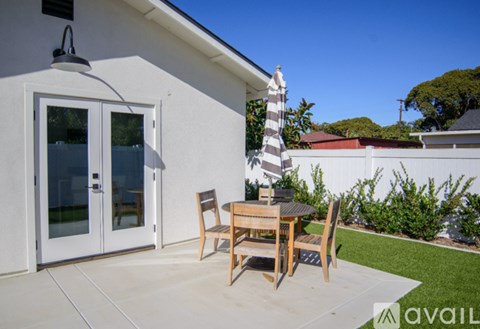 A patio with a table and chairs is available for rent.