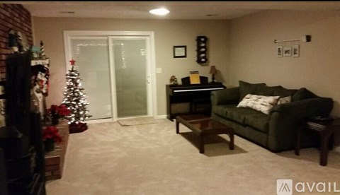 A living room with a green couch and a coffee table.