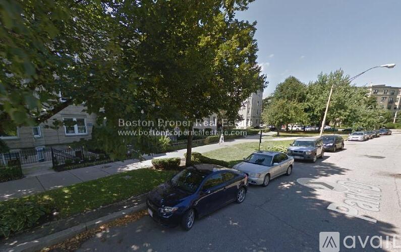 A street view of Boston Eroper Real Estate with cars parked on the side of the road.