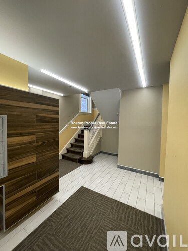 A hallway with a wooden wall and a carpeted floor.