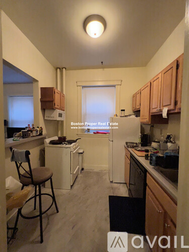 A kitchen with a chair and a window.