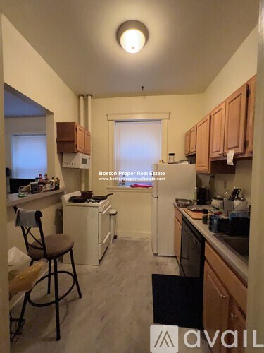 A kitchen with a chair and a window.