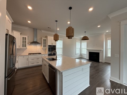 A modern kitchen with white cabinets and a large island.