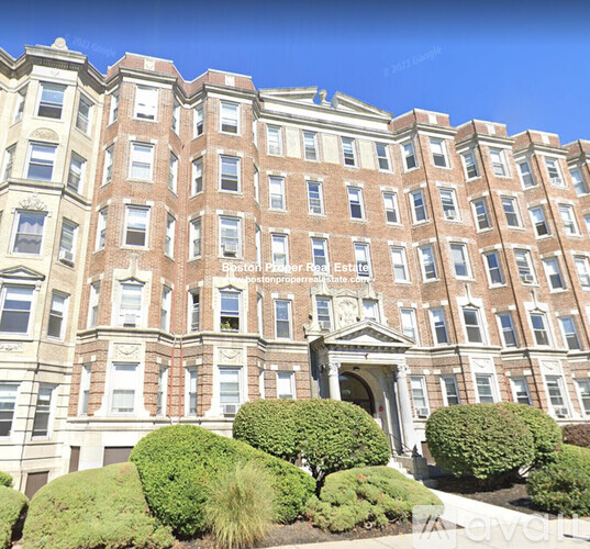 A large, multi-story building with a symmetrical facade and a central entrance.