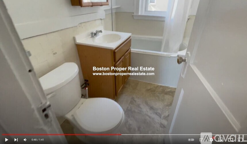 A bathroom with a toilet, sink, and a mirror.