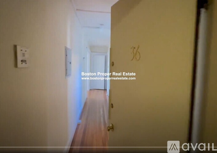 A hallway with a door numbered 36.