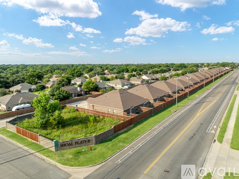 A grey door with a window is on a brick wall.