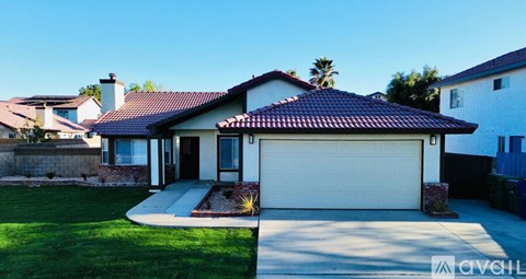A house with a red tile roof and a white garage door.