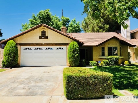 A house with a white garage door and a brown roof.