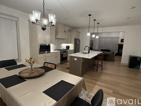 A modern kitchen with a dining table set for four.