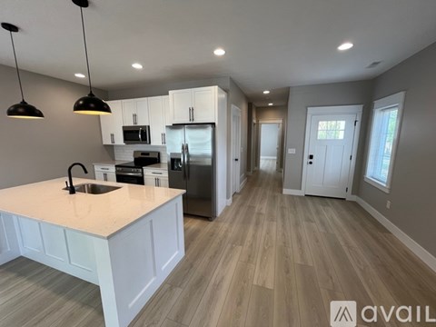 A kitchen with a sink and a refrigerator.