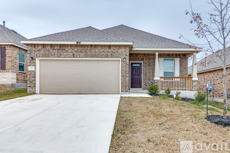 A house with a garage and a driveway in front.