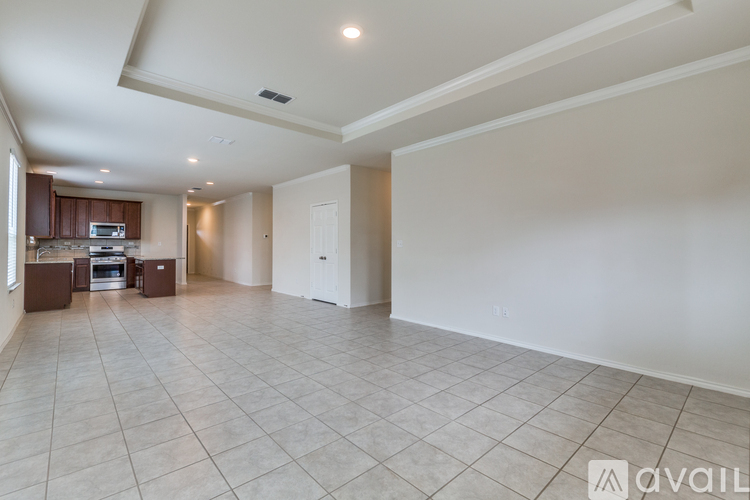 A spacious room with a kitchen area and a large open space.