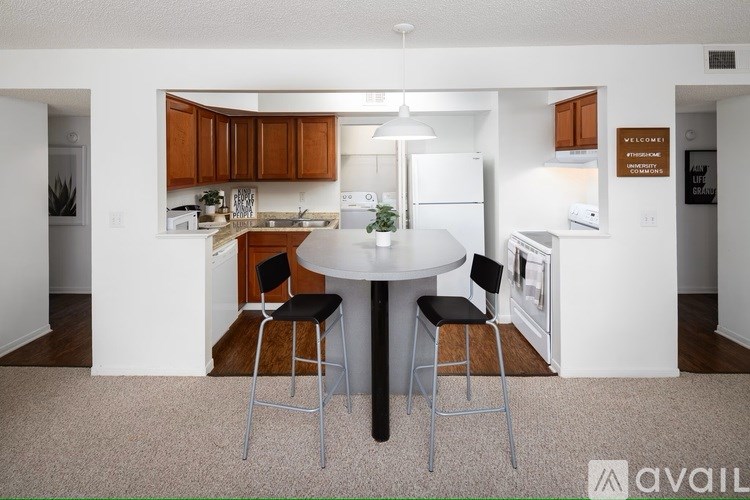 A kitchen with a table and chairs in the middle of it.