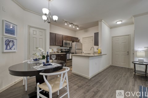 A modern kitchen with a dining table and chairs.