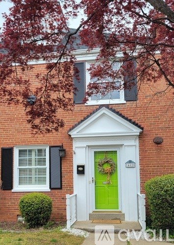 A house with a green door and a wreath on it.