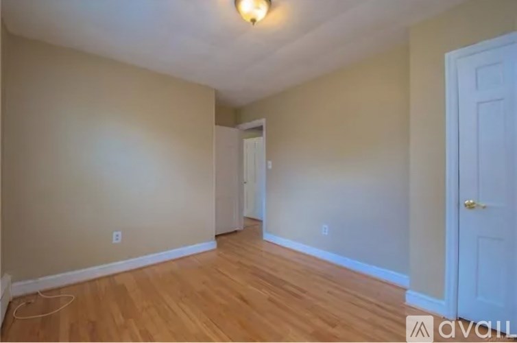 A room with wooden floors and a white door.