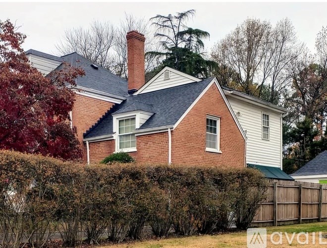 A house with a red brick chimney and a white roof.
