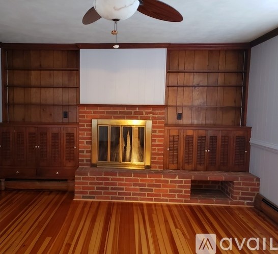 A room with a fireplace and wooden floors.