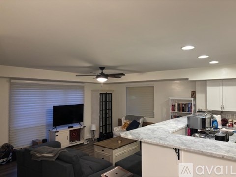 A living room with a grey couch and a television.