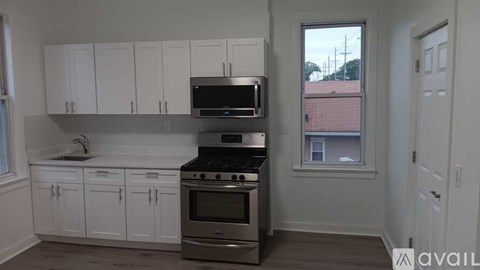 A kitchen with white cabinets and stainless steel appliances.