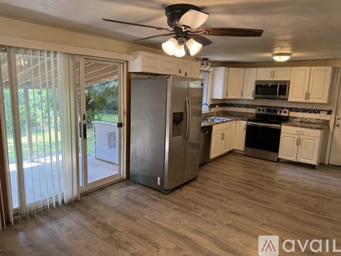 A kitchen with a refrigerator, stove, and oven.