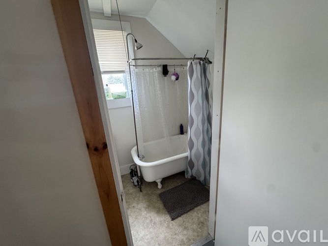 A white toilet and bathtub in a small bathroom.