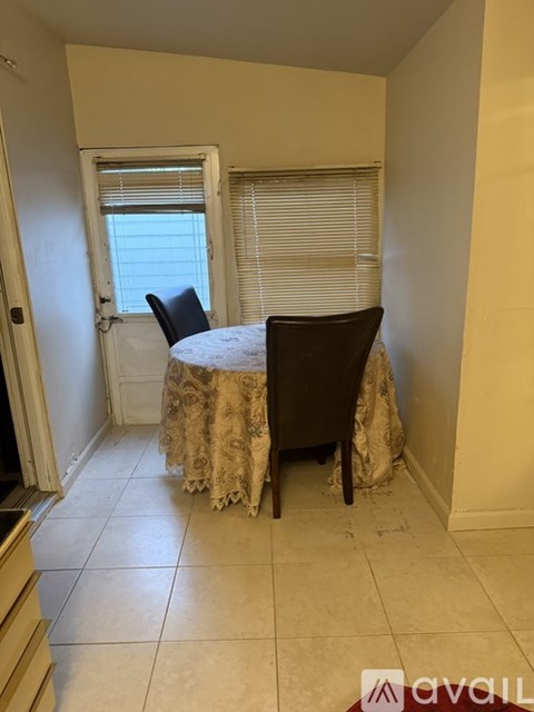 A dining room with a table and chairs.