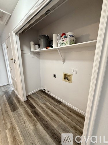 A kitchen pantry with a white cabinet and a white door.
