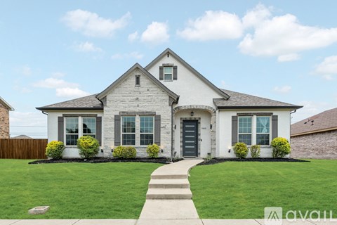 A white house with a black front door and windows.